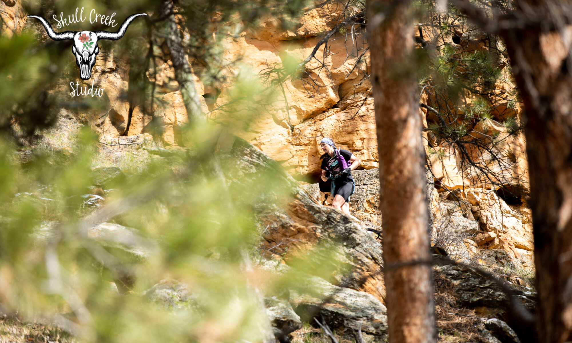 Runner behind trees Cave Man Fun Run
